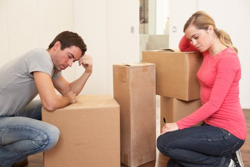 Removal team loading household furniture into a van on moving day
